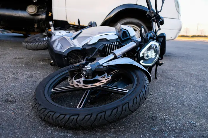 $2.35M Settlement Secured After Michigan Motorcycle Accident. A motorcycle laying on its side in the middle of a street.