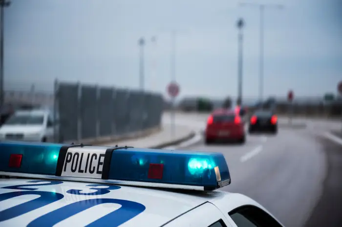 Police car following cars inside a city with motion blur effect; $5.24M Settlement Reached in High-Speed Chase that Resulted in Death of Fetus