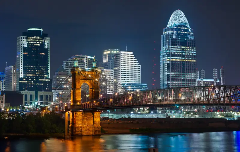 Cincinnati skyline. Image of Cincinnati and John A. Roebling suspension bridge at night.