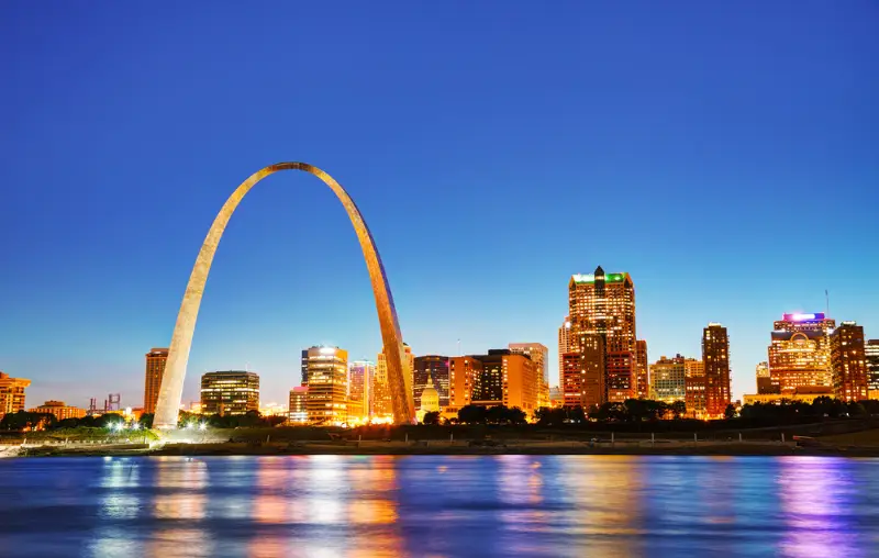 Downtown St Louis, MO with the Old Courthouse and the Gateway Arch at sunset