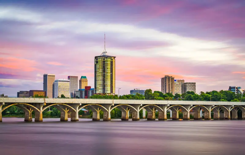 Tulsa, Oklahoma, USA downtown skyline on the Arkansas River at dusk.