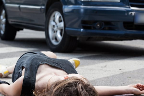 A dead woman in blood after a car accident