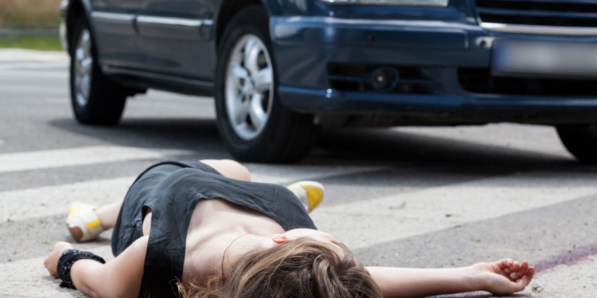 A dead woman in blood after a car accident