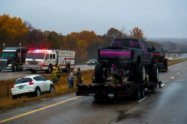 $1 Million Settlement | Traffic accident on interstate 44 on a rainy day with police and fire department on site, picture taken through a windshield.